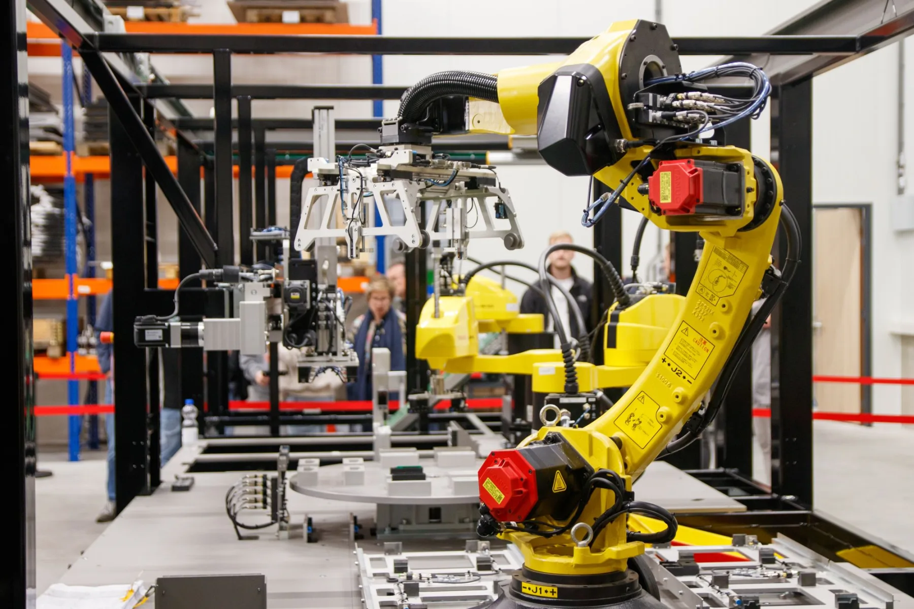 An industrial robotic arm works inside a manufacturing facility.