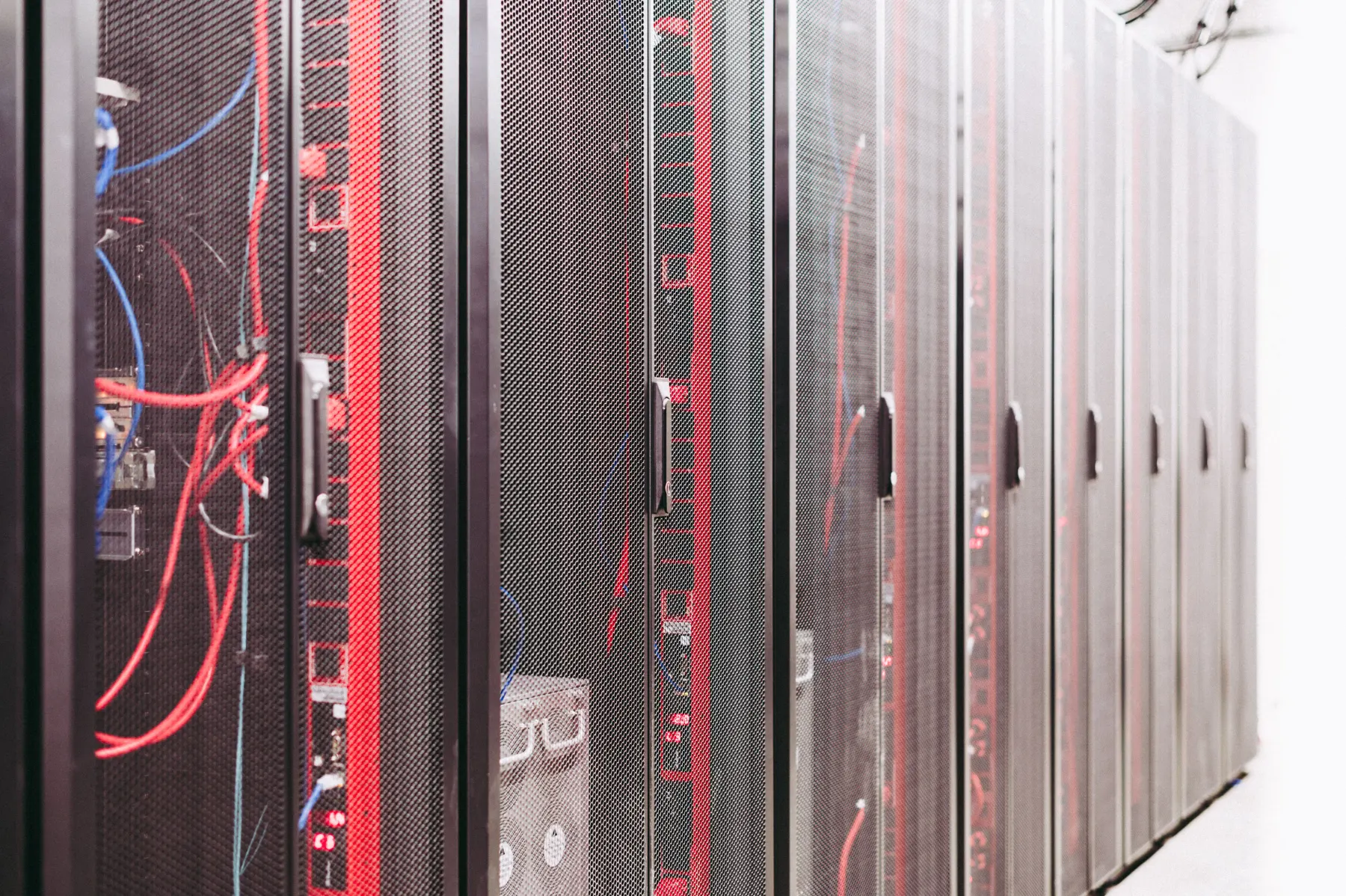 Rows of server racks connected by network cables
