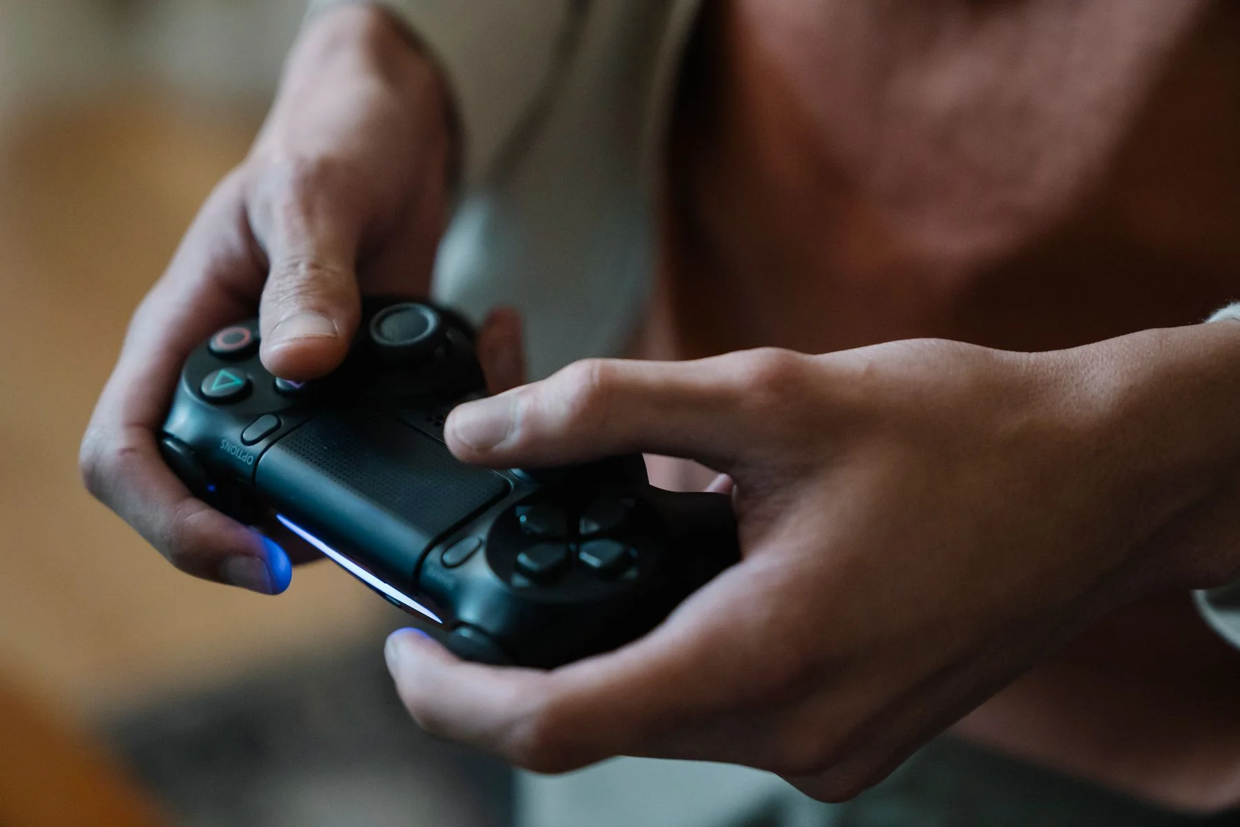 Two people playing a video game together in a dimly lit room.