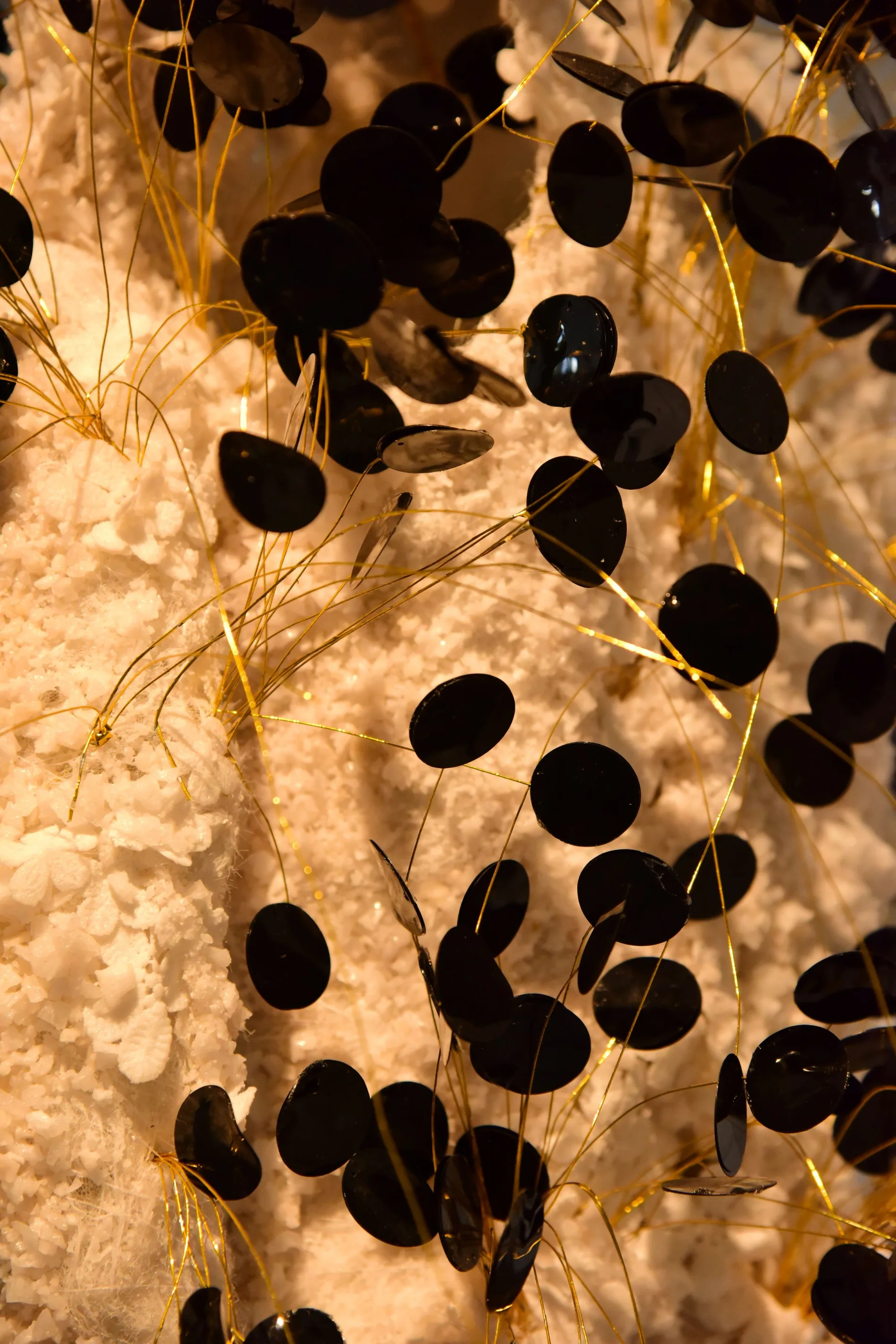 Black discs connected by fine threads in an abstract arrangement.