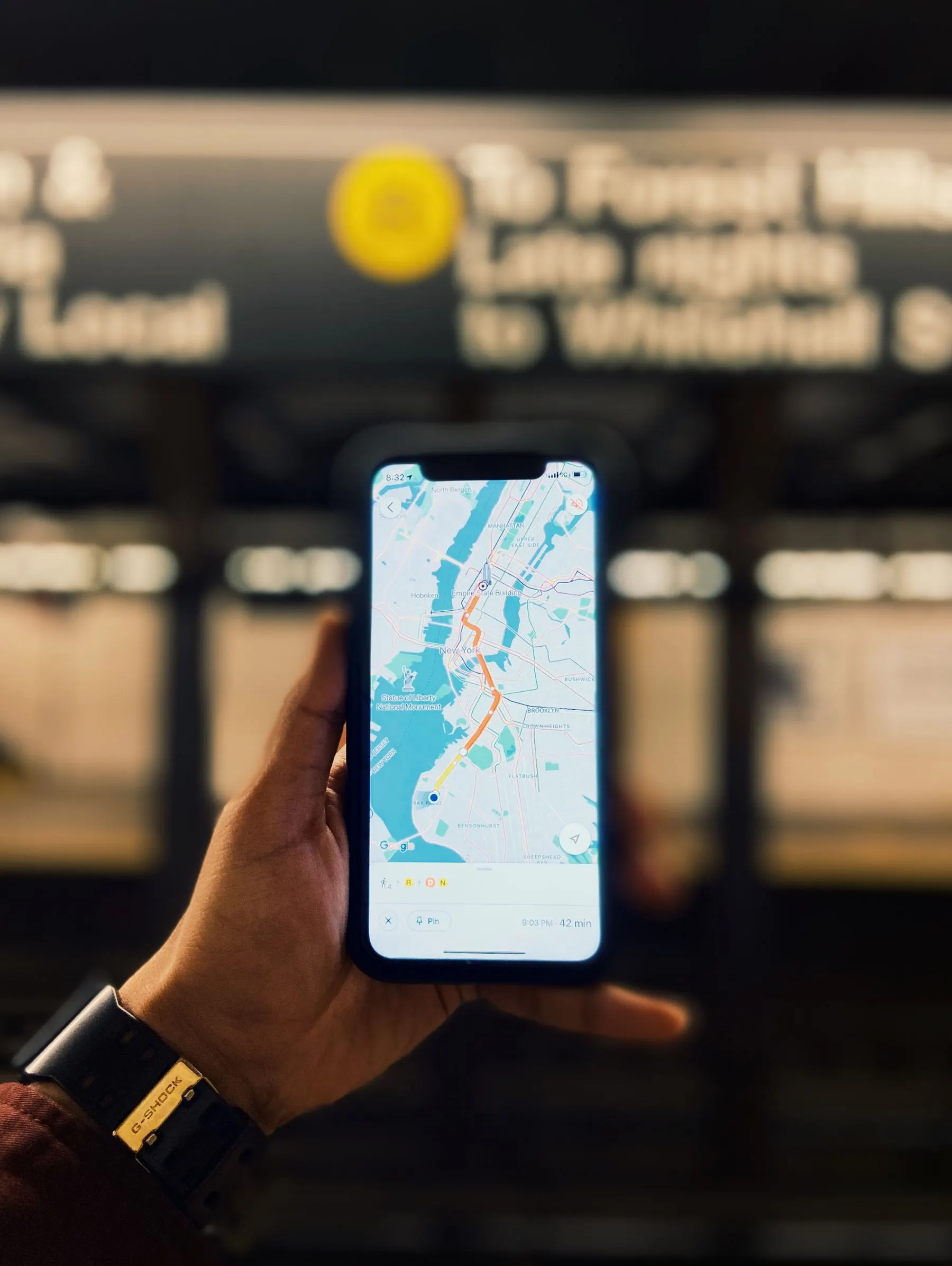 A phone displays a city map while its user checks a location.